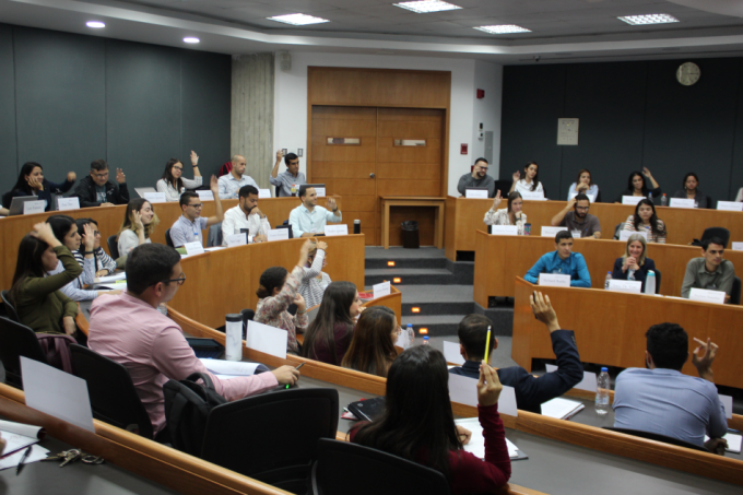 Raising a hand in the classroom at IESA Venezuela